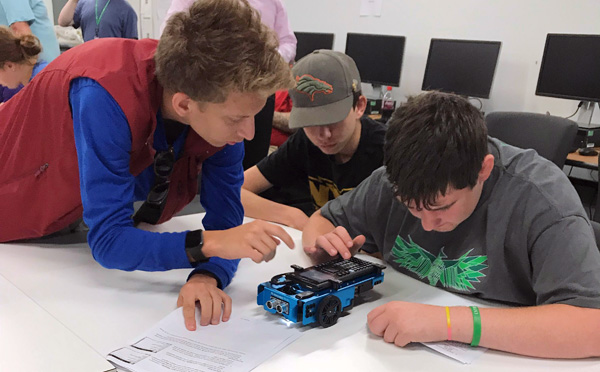 Students programming a Texas Instruments Innovator Rover, a small table top robot